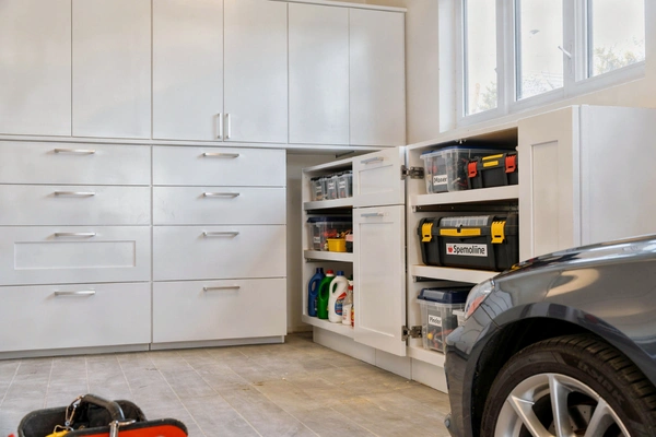Custom garage storage cabinets with pull-out drawers and organized tool storage